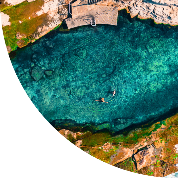 A woman swimming in crystal clear water